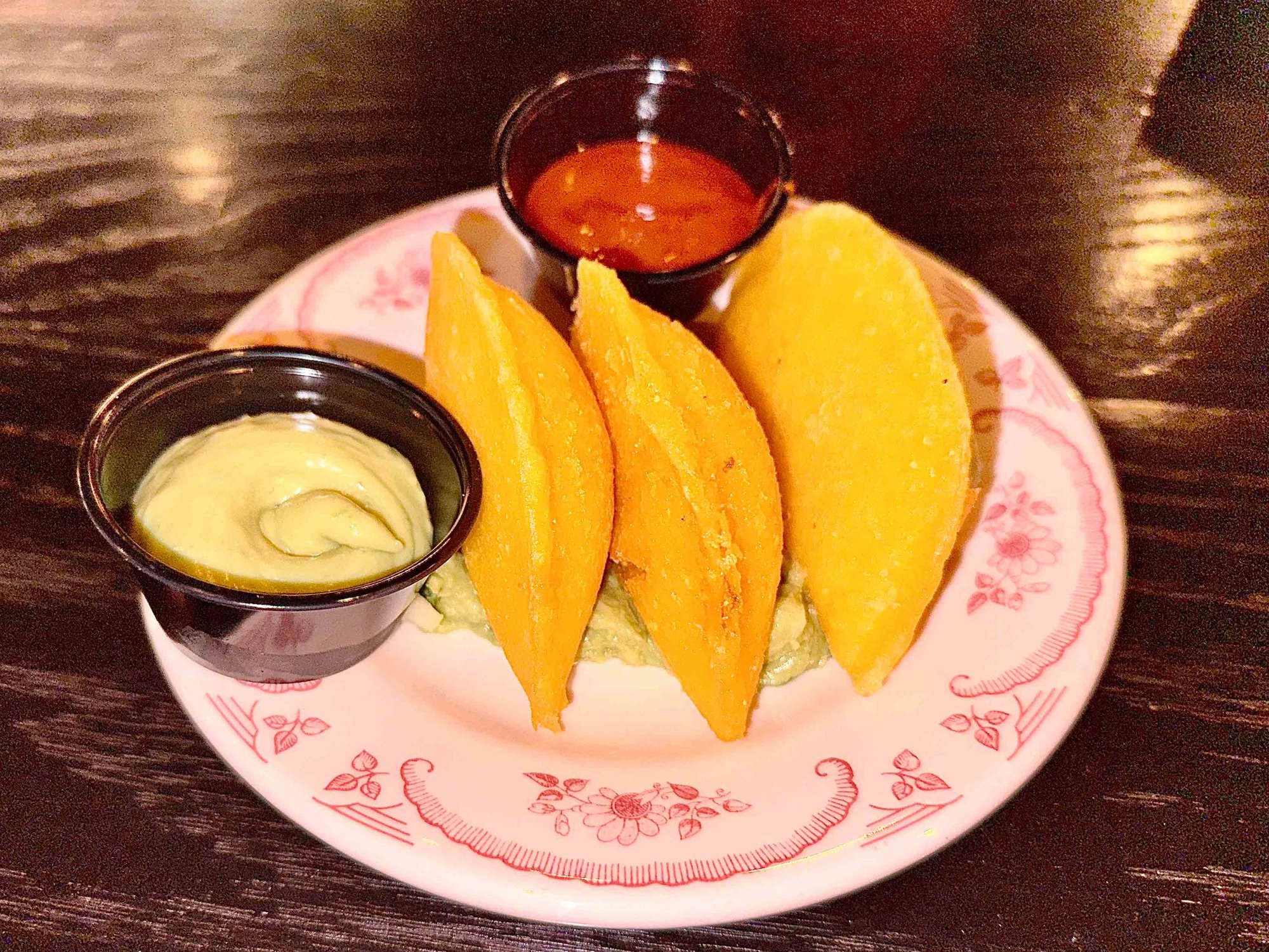 beef empanadas on a plate with dipping sauces